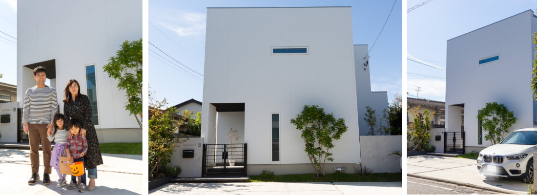 白を基調としたシンプルモダンな外観の前に並ぶ、ご家族4人の穏やかな佇まい。窓を最小限に抑えた白い箱型フォルムが印象的な、シンプルモダンの住宅外観。植栽と白い外壁が調和した、街並みに映えるシンプルな住宅外観