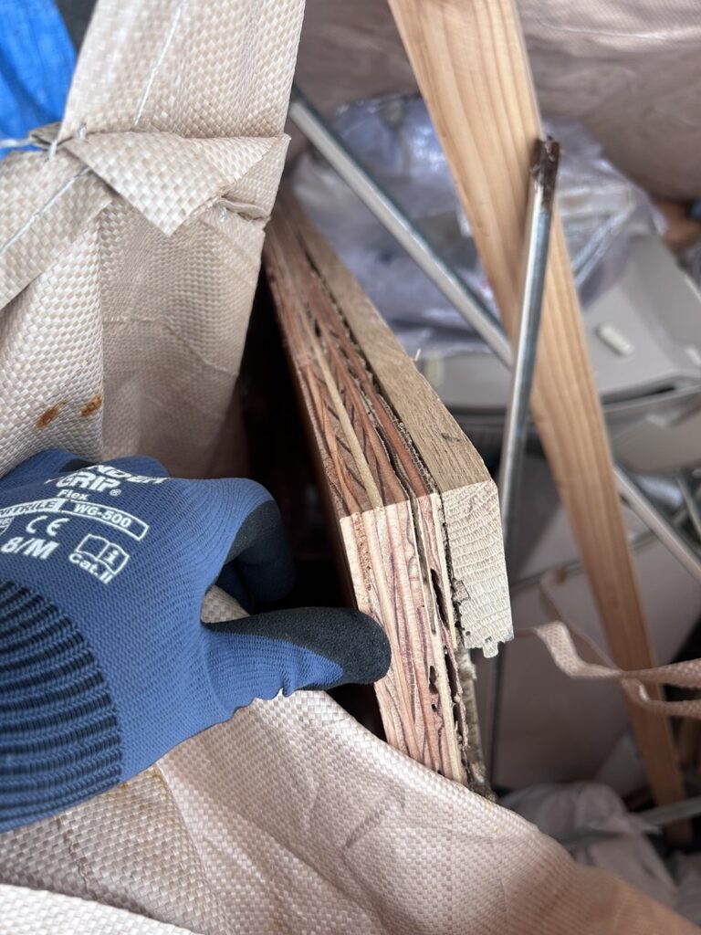 白蟻に食われて断面がボロボロになった合板フローリング材